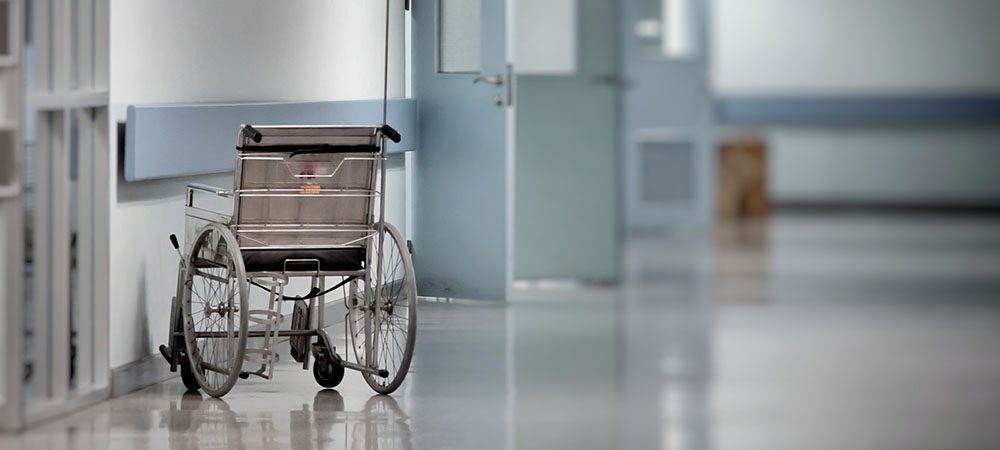 Wheelchair empty wait to use at hospital hallway.