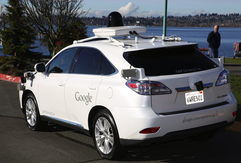 Google personnel parked a retrofitted Lexus SUV with self-driving technology at Kirkland's Marina for a glamour shot, Tues., Feb. 2, 2016. Google will start testing its self-driving technology here in the NW. In the background, a passerby checks out the car.