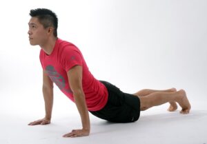 Man stretching lower back to help with back pain